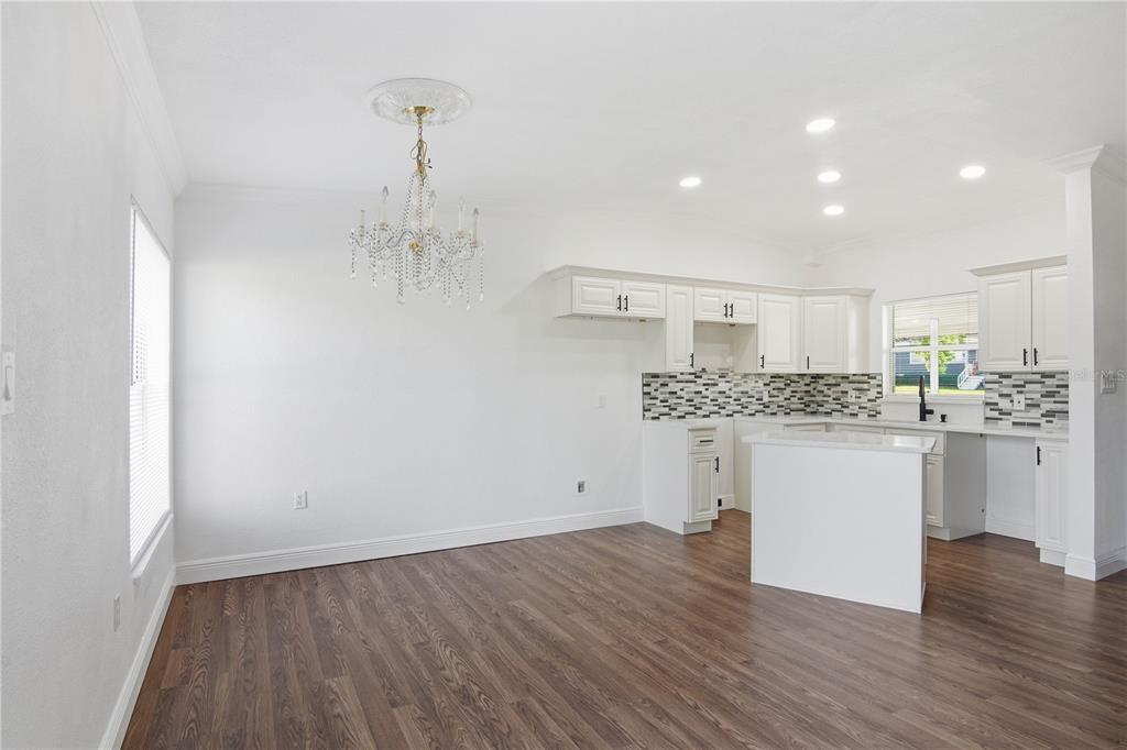 5601 Meridian Way Orlando, FL 32808 - Photo 8 of 34 a kitchen with a refrigerator and white cabinets