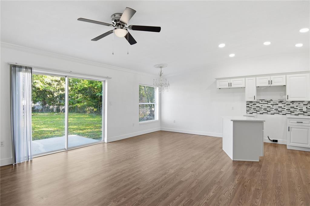 5601 Meridian Way Orlando, FL 32808 - Photo 9 of 34 a view of kitchen with wooden floor and window