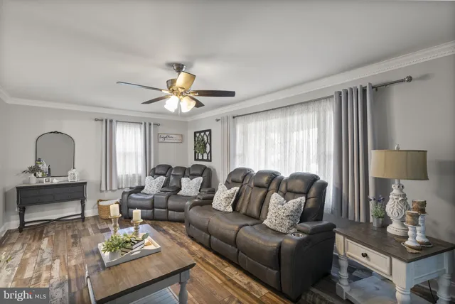 a kitchen with stainless steel appliances granite countertop a sink dishwasher stove and refrigerator with wooden floor