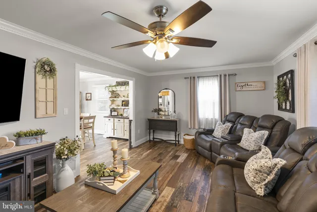 a living room with furniture a window and a flat screen tv