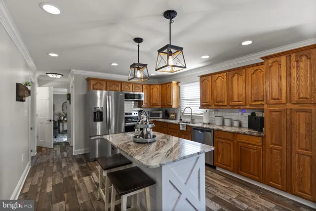 a living room with furniture a window and a flat screen tv