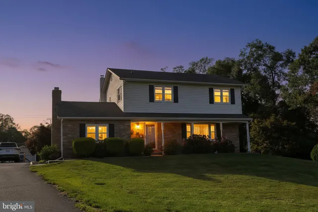 a front view of a house with potted plants