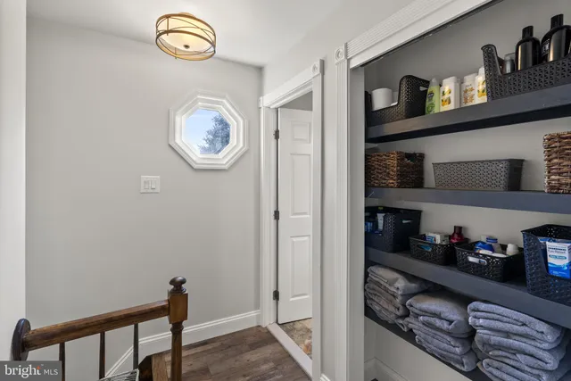 a view of walk in closet with clothes