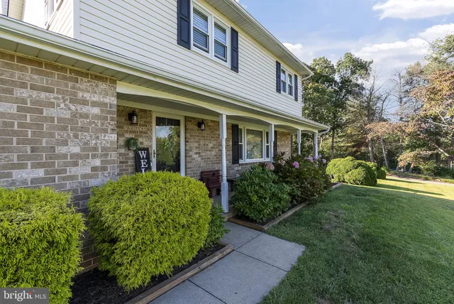 a view of a porch with chairs and potted plants