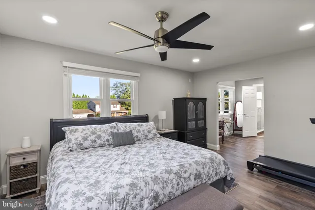 a bathroom with a double vanity sink toilet mirror and shower
