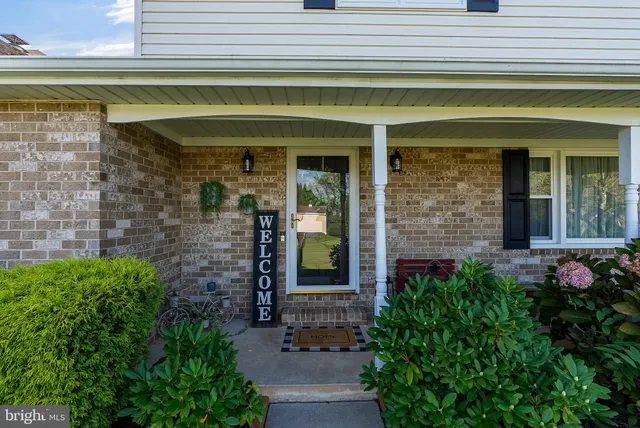 a view of a hallway with wooden floor and entryway