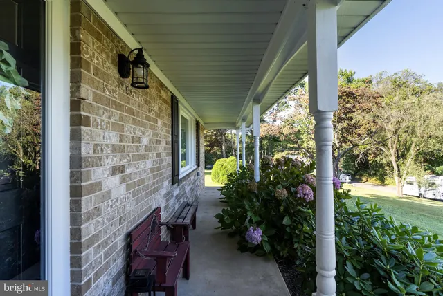 a view of a hallway with wooden floor and entryway
