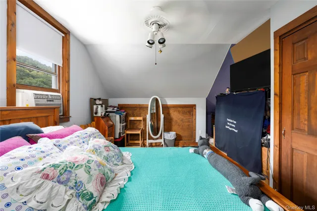 a bedroom with bed and a large window