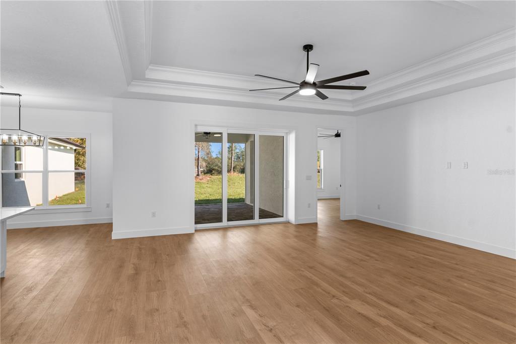8090 Nordica Road Brooksville, FL 34613 - Photo 13 of 56 a view of an empty room with a window and wooden floor