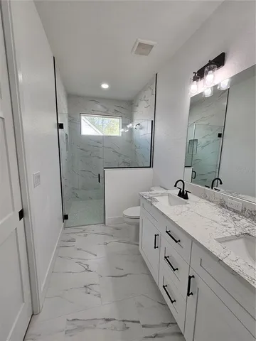 a bathroom with a double vanity sink and mirror