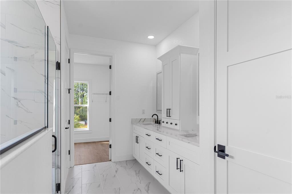 8090 Nordica Road Brooksville, FL 34613 - Photo 20 of 56 a bathroom with a double vanity sink and mirror