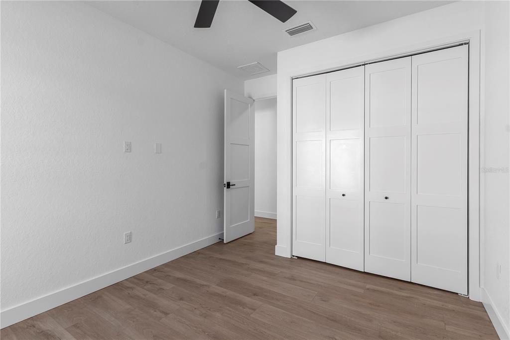 8090 Nordica Road Brooksville, FL 34613 - Photo 29 of 56 a view of an empty room with wooden floor