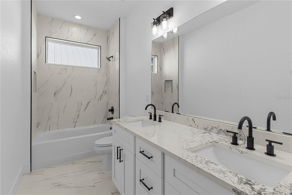 8090 Nordica Road Brooksville, FL 34613 - Photo 30 of 56 a bathroom with a granite countertop sink a toilet and shower