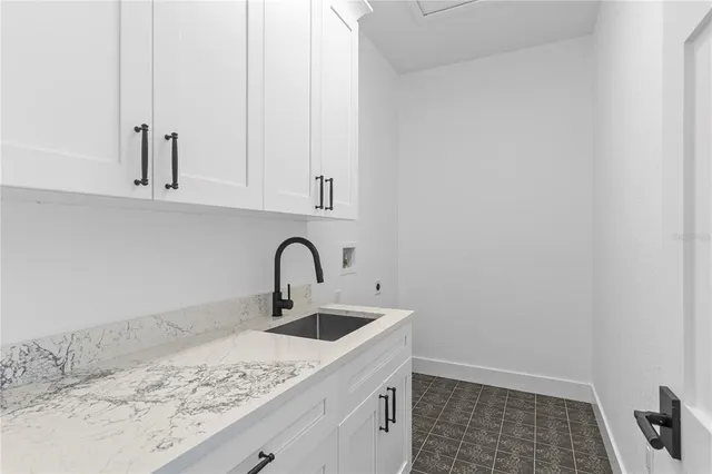 a view of a kitchen with stainless steel appliances granite countertop a stove a sink and a refrigerator with wooden floor