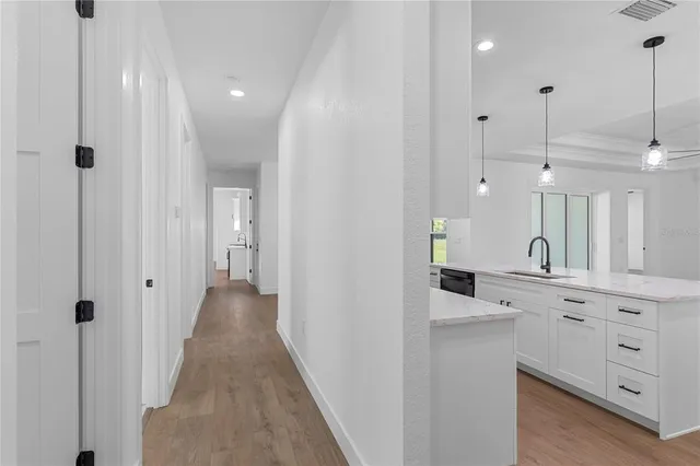 a view of a kitchen with a stove cabinets and wooden floor