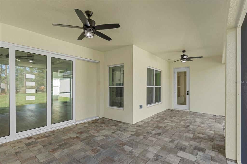 8090 Nordica Road Brooksville, FL 34613 - Photo 45 of 56 a view of a livingroom with a ceiling fan & entryway