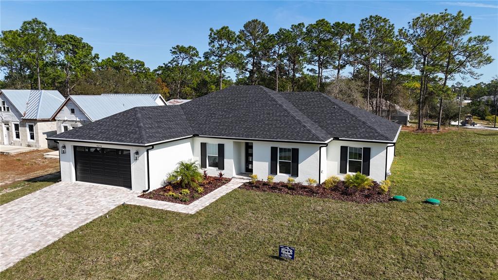 8090 Nordica Road Brooksville, FL 34613 - Photo 50 of 56 front view of a house with a yard