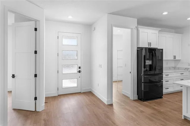 a kitchen with stainless steel appliances a stove refrigerator and cabinets