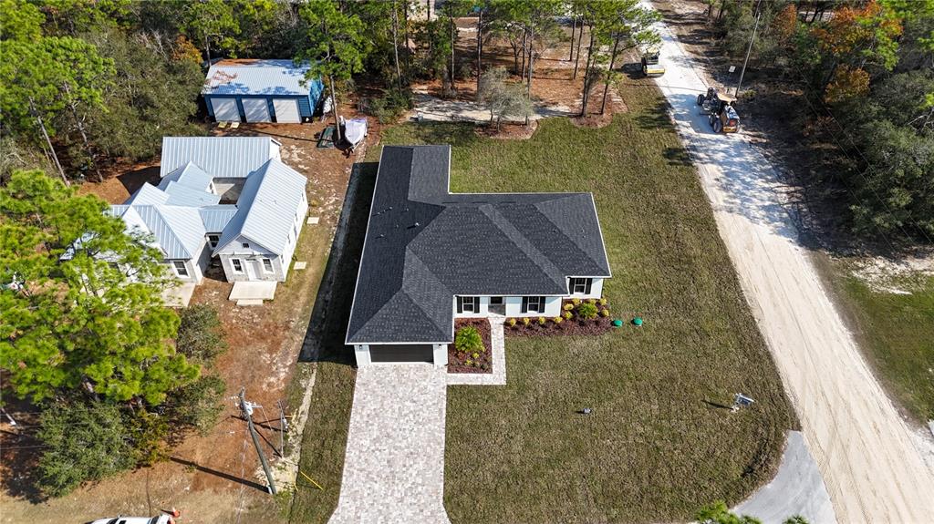 8090 Nordica Road Brooksville, FL 34613 - Photo 53 of 56 an aerial view of a house with a yard