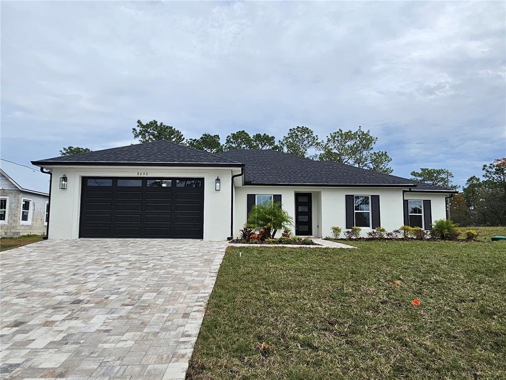 8090 Nordica Road Brooksville, FL 34613 - Photo 56 of 56 front view of a house with a yard