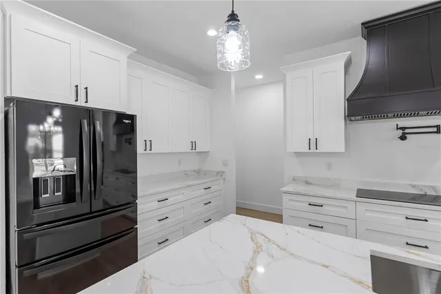 a kitchen with stainless steel appliances a stove refrigerator and microwave