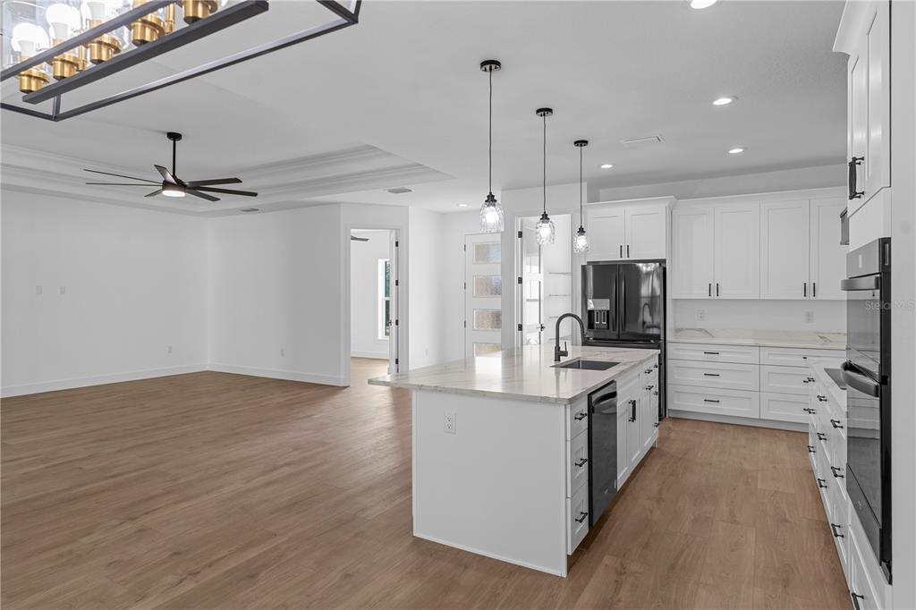 8090 Nordica Road Brooksville, FL 34613 - Photo 8 of 56 a kitchen with stainless steel appliances a stove refrigerator and microwave