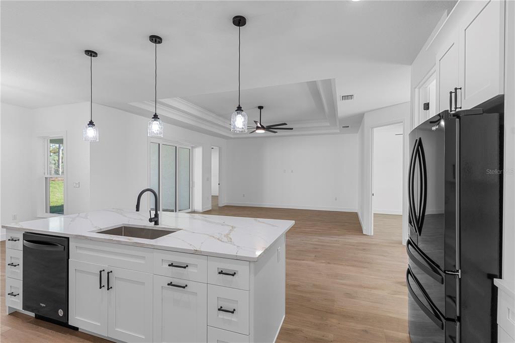 8090 Nordica Road Brooksville, FL 34613 - Photo 9 of 56 a kitchen with stainless steel appliances a sink a refrigerator a center island a stove and a sink