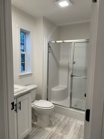 a white toilet sitting next to a bathroom sink