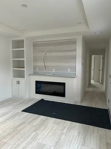 a living room with a black dresser