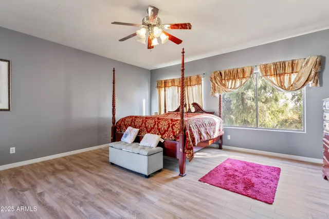 a bedroom with a bed and a chandelier