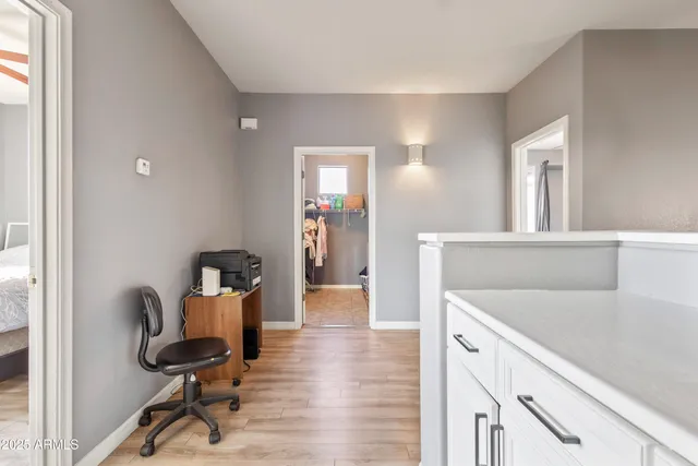 a view of a workspace with furniture and wooden floor