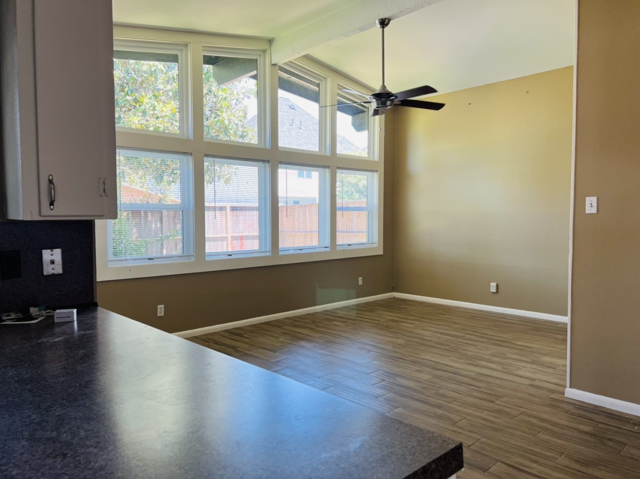 4731 Merwin Street Houston, TX 77027 - Photo 1 of 28 an empty room with wooden floor and windows