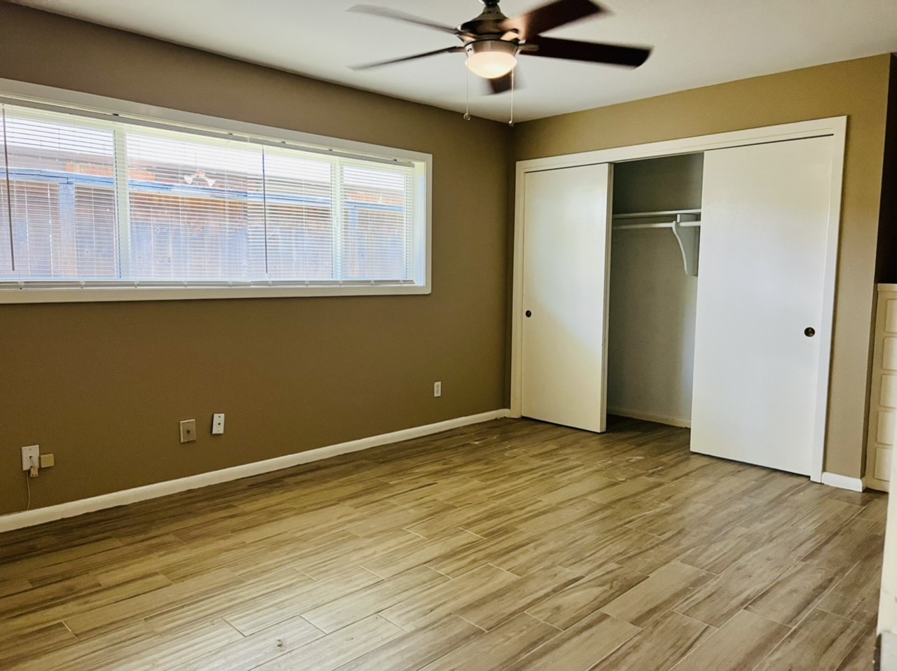 4731 Merwin Street Houston, TX 77027 - Photo 11 of 28 a view of an empty room with wooden floor and a window