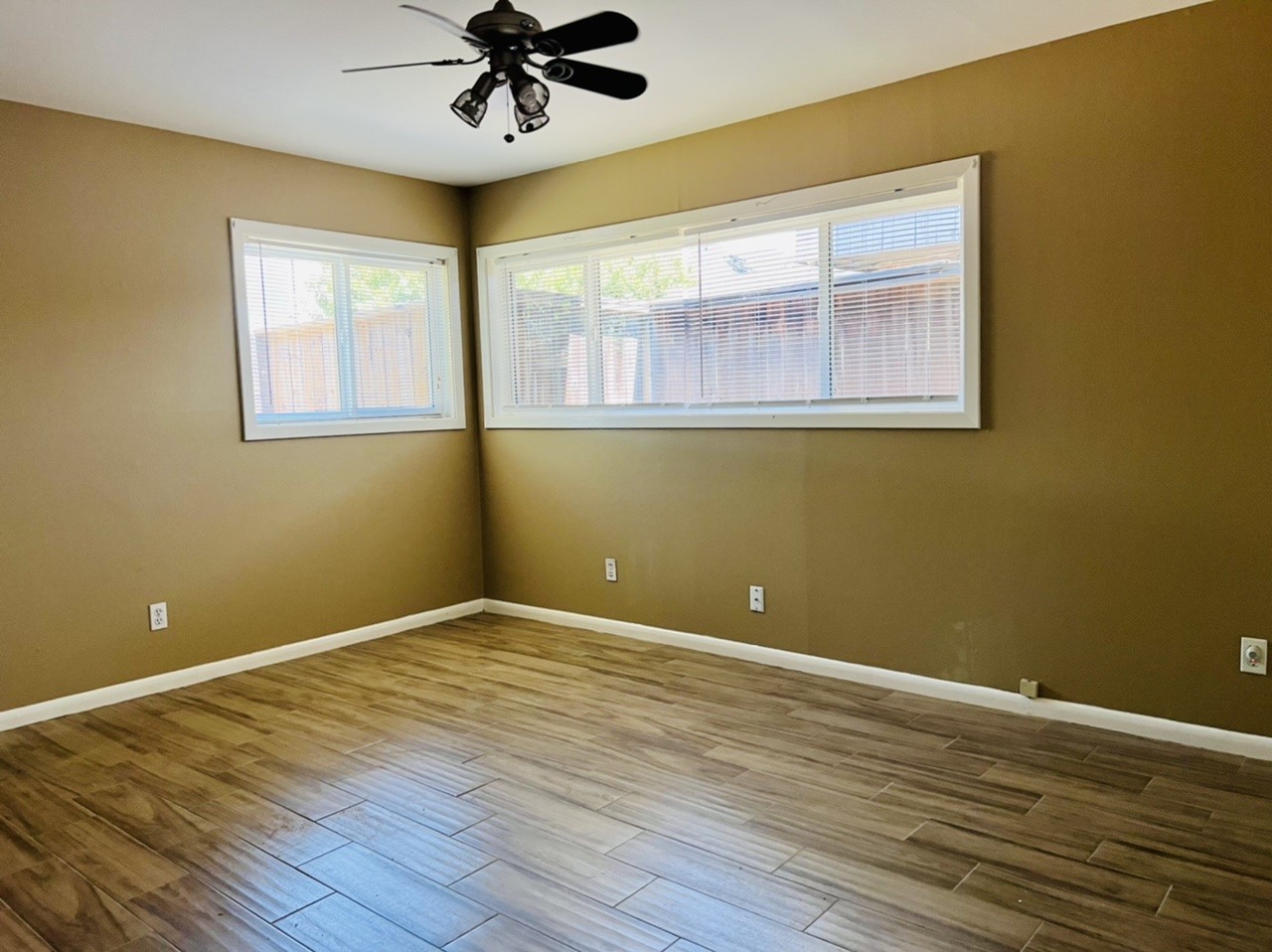 4731 Merwin Street Houston, TX 77027 - Photo 13 of 28 a view of empty room with wooden floor and fan