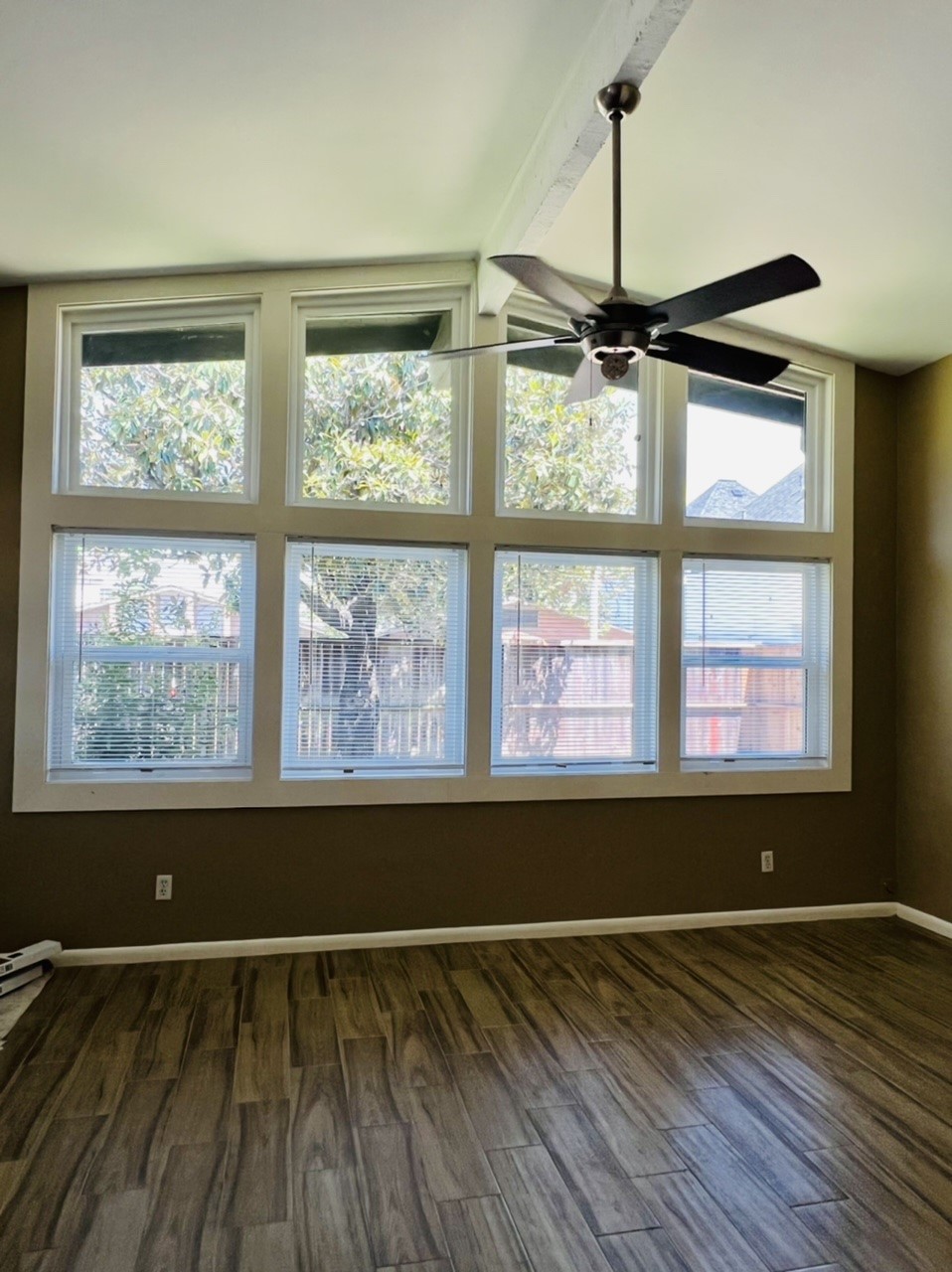 4731 Merwin Street Houston, TX 77027 - Photo 18 of 28 a view of an empty room with wooden floor and a window