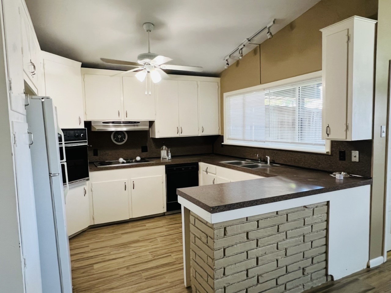 4731 Merwin Street Houston, TX 77027 - Photo 19 of 28 a kitchen with stainless steel appliances granite countertop a sink stove and refrigerator
