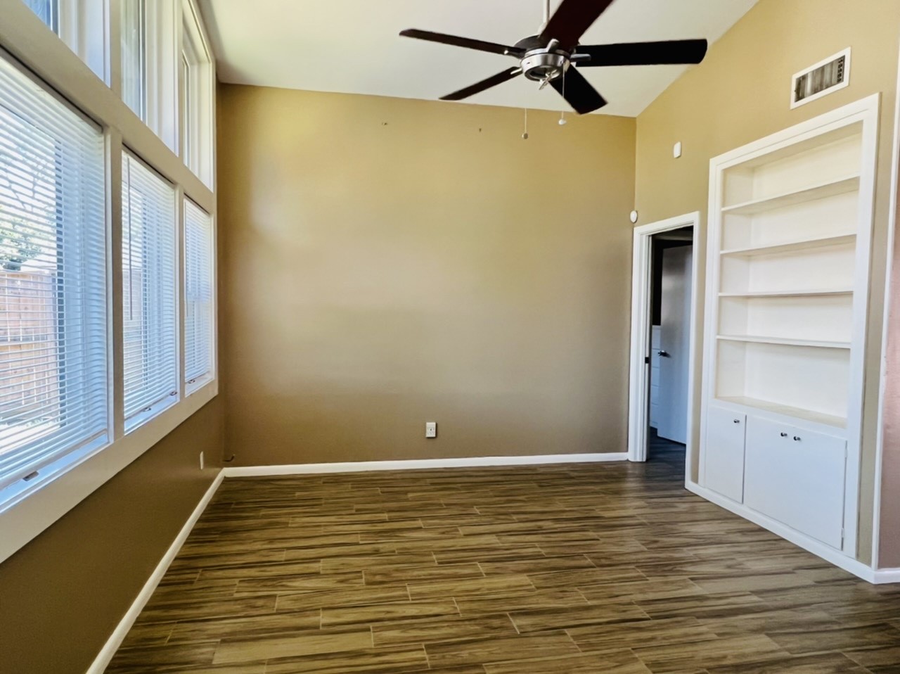 4731 Merwin Street Houston, TX 77027 - Photo 23 of 28 a view of an empty room with a window and wooden floor