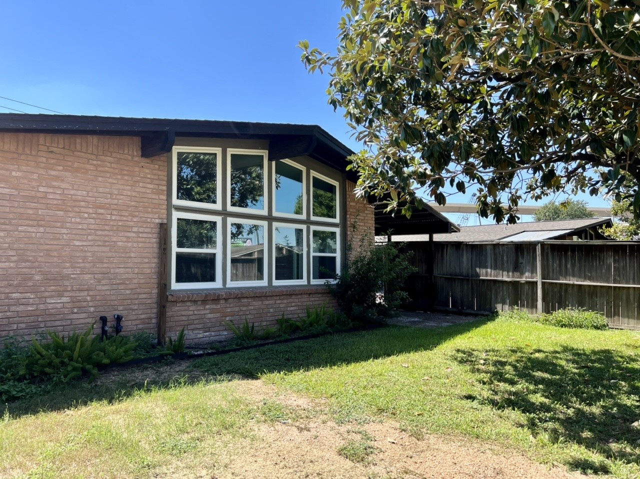 4731 Merwin Street Houston, TX 77027 - Photo 24 of 28 a view of house with backyard space and garden