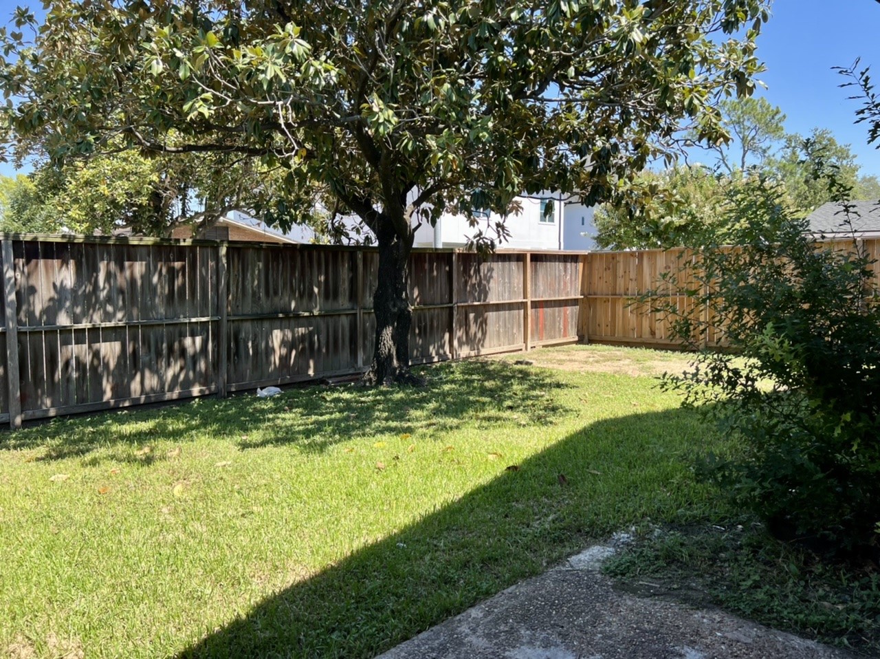 4731 Merwin Street Houston, TX 77027 - Photo 25 of 28 a view of a backyard with wooden fence