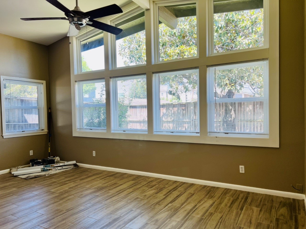 4731 Merwin Street Houston, TX 77027 - Photo 4 of 28 an empty room with wooden floor and windows