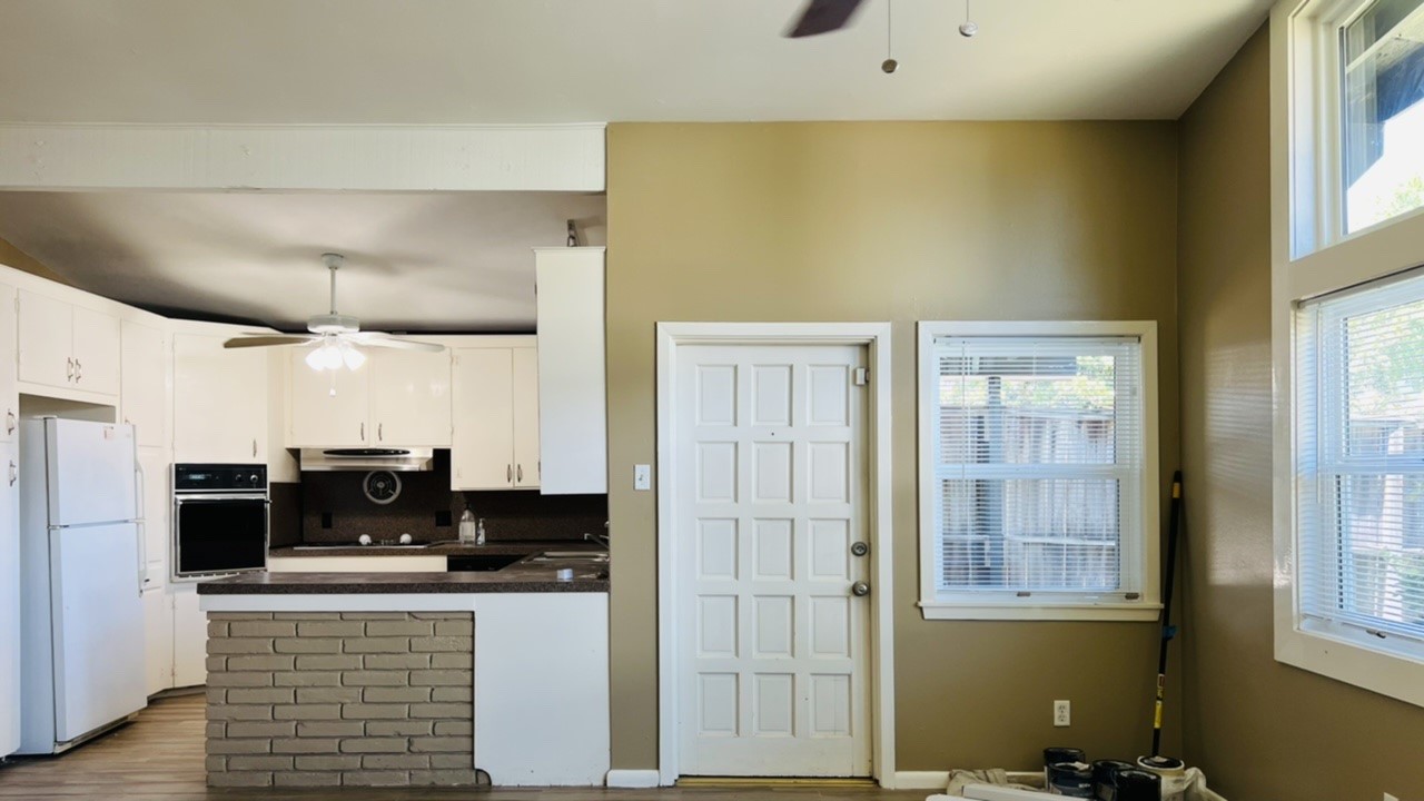 4731 Merwin Street Houston, TX 77027 - Photo 6 of 28 a kitchen with stainless steel appliances granite countertop a refrigerator and a stove