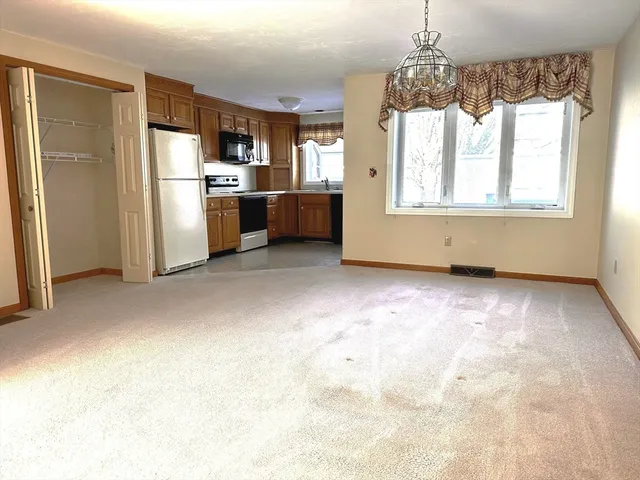 a kitchen with refrigerator and window