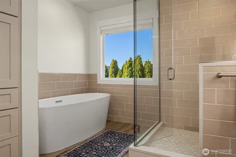 a bathroom with a bathtub and a shower