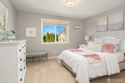 a bedroom with a bed and a desk