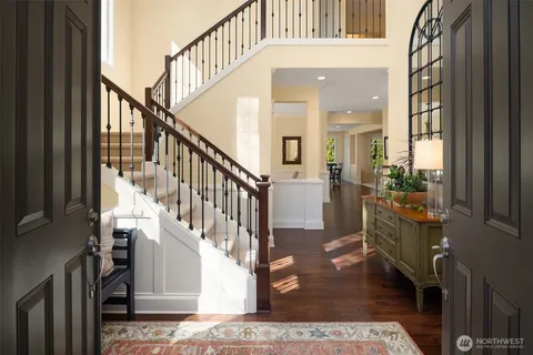 a view of entryway and hall with wooden floor