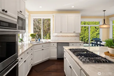 a kitchen with stainless steel appliances a stove sink and cabinets