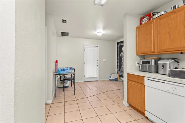 a kitchen with granite countertop a sink cabinets and window