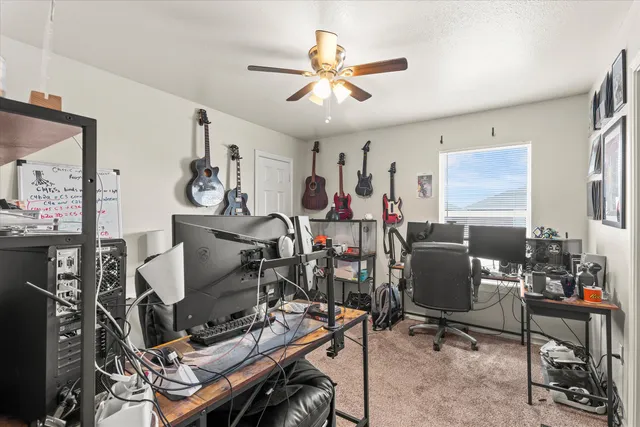 a view of a workspace with furniture and a window