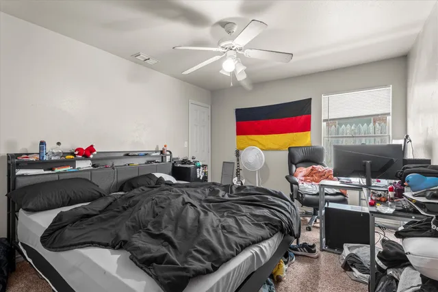 a bedroom that has a bed and a chair in it