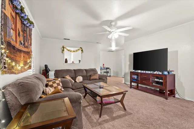 a living room with furniture and a flat screen tv